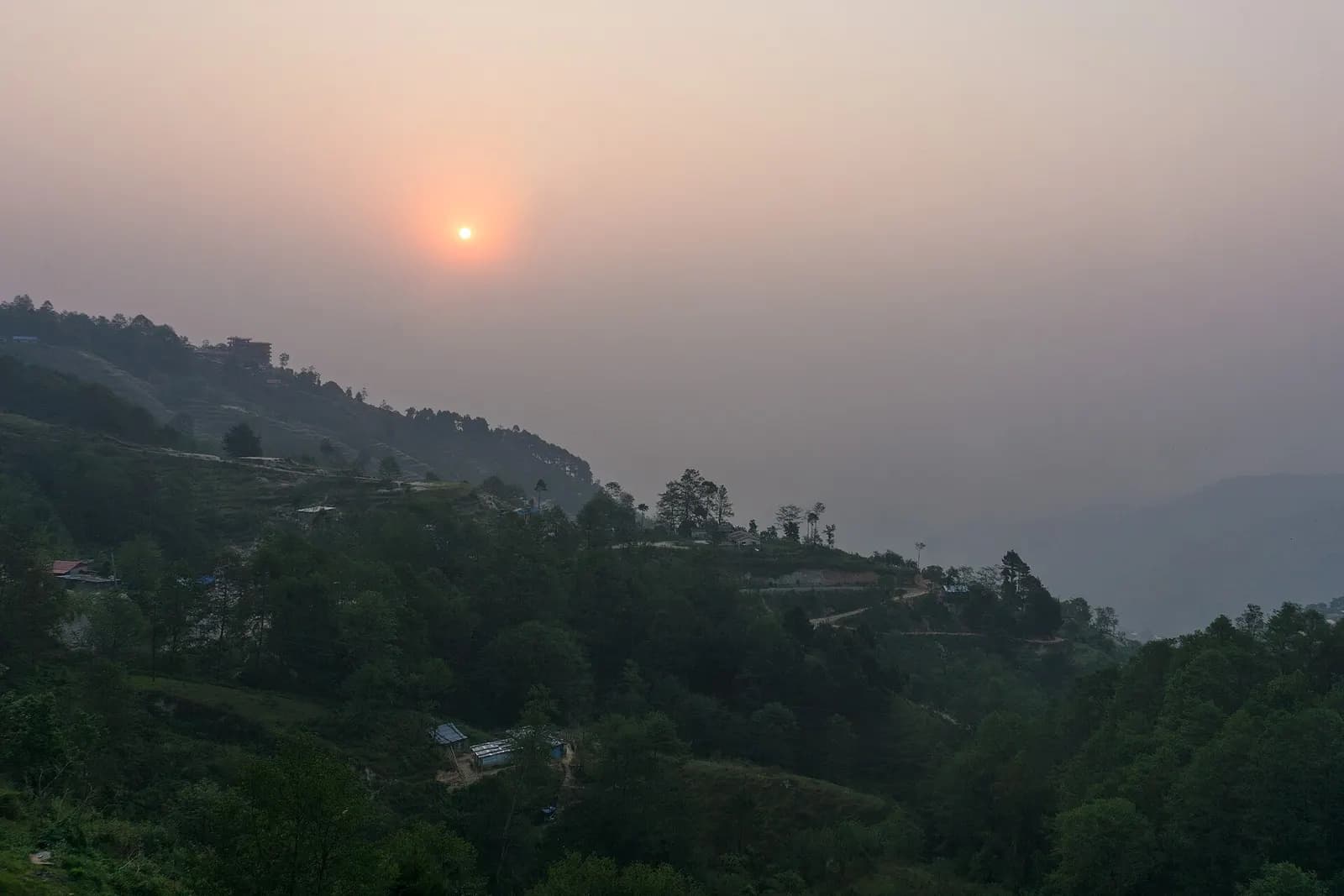 Sunrise over the hills from a hotel rooftop in Nagarkot