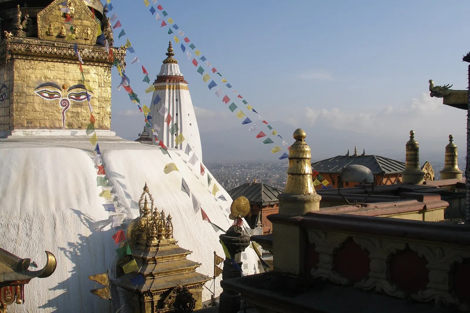 Prayer flags and the gilded spire of Swayambhunath above Kathmandu