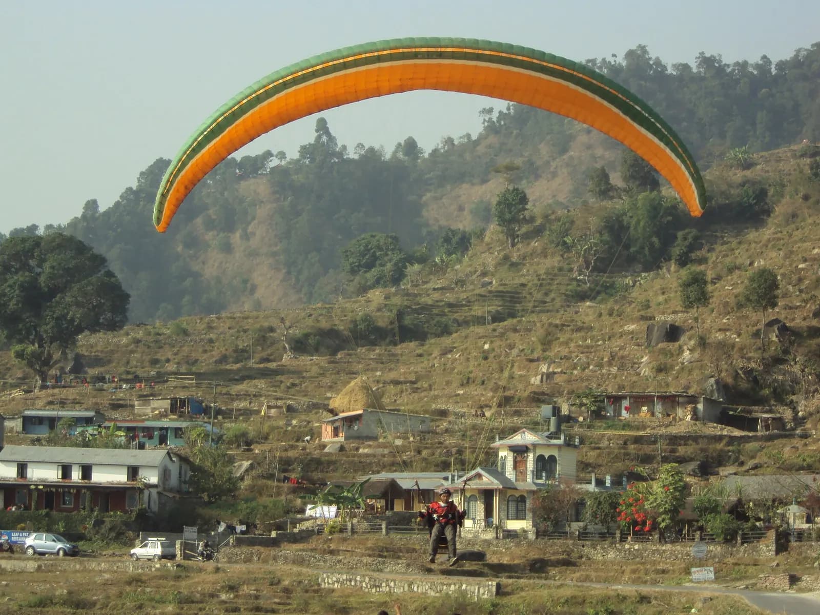 A paraglider coming in to land near Phewa Lake
